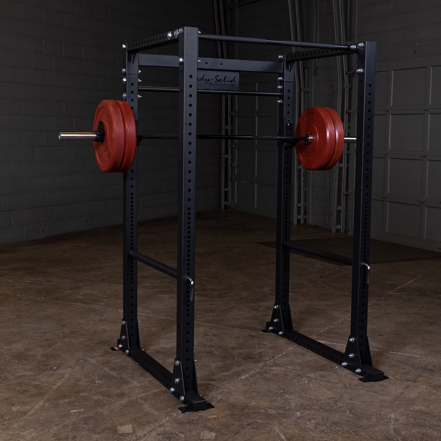 Full view of the Body‑Solid GPR400 power rack in a home gym with weights