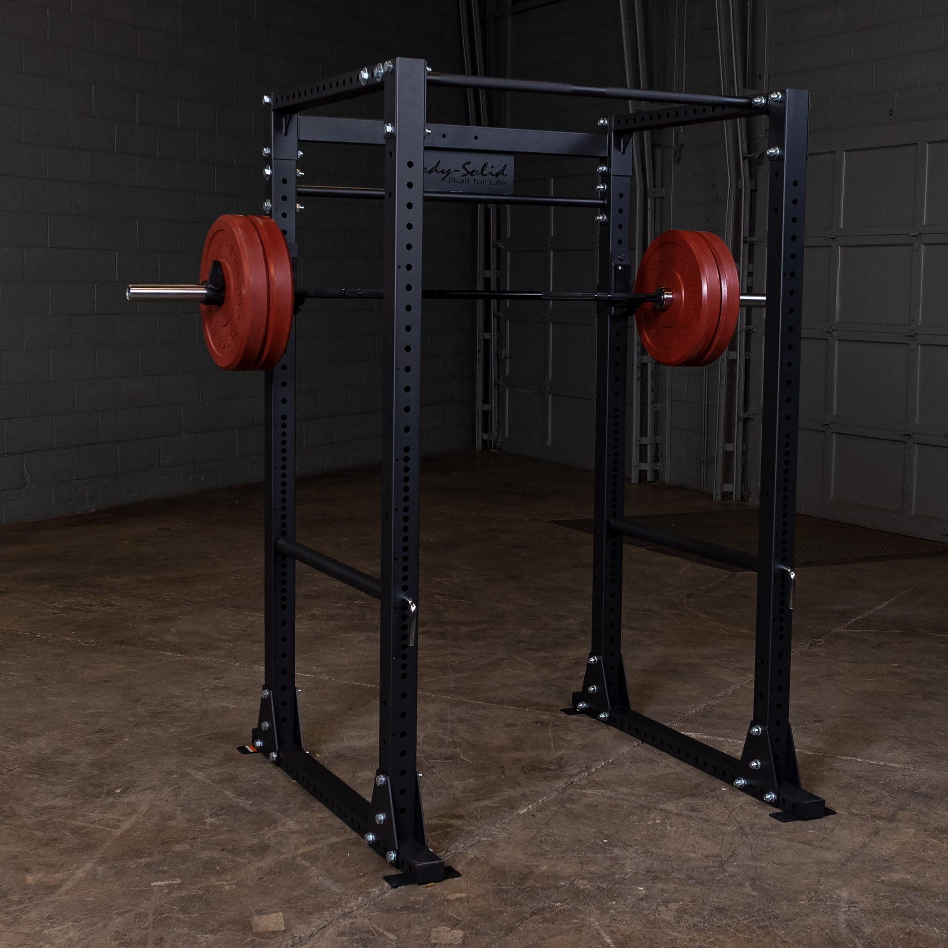 Full view of the Body‑Solid GPR400 power rack in a home gym with weights