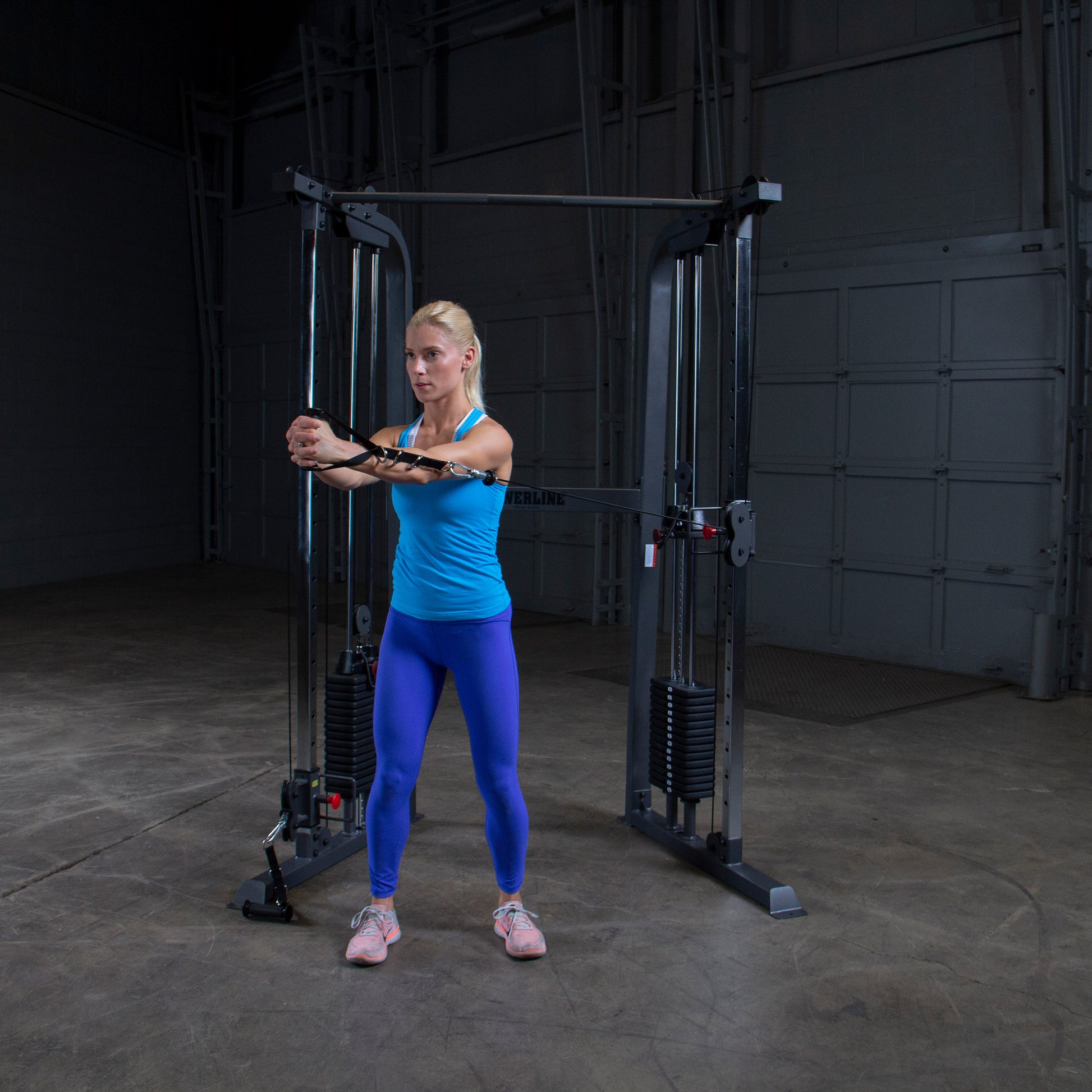 Athlete performing an ab workout on Body-Solid Powerline PFT100 Functional Trainer with smooth cable operation.