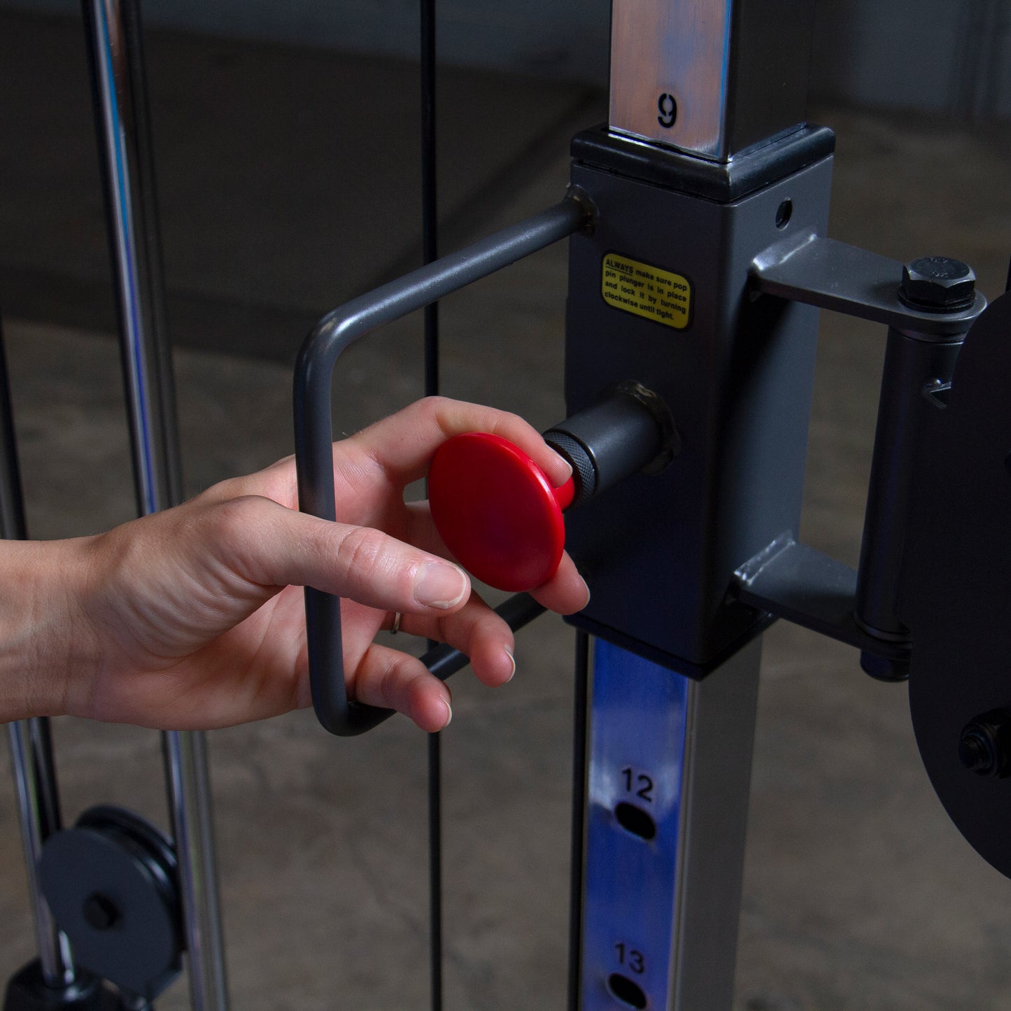 Adjustable pulley system on Body-Solid Powerline PFT100 Functional Trainer for versatile strength training exercises.