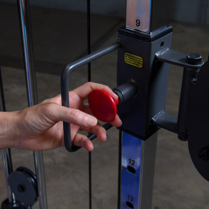 Adjustable pulley system on Body-Solid Powerline PFT100 Functional Trainer for versatile strength training exercises.