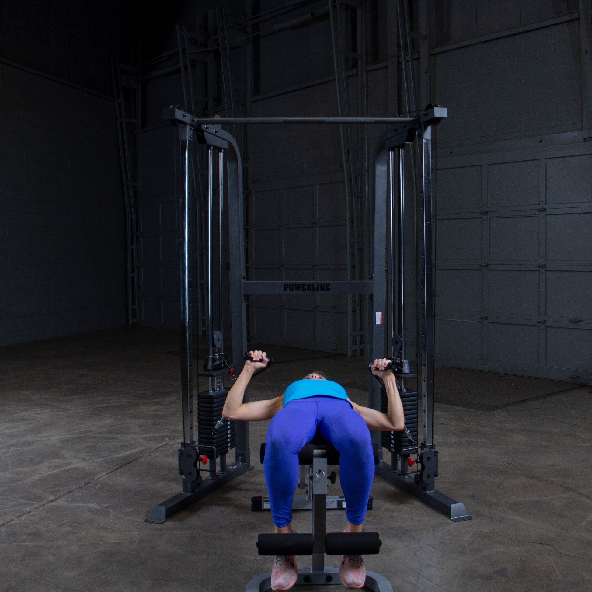 Athlete performing a chest workout on Body-Solid Powerline PFT100 Functional Trainer with smooth cable operation.