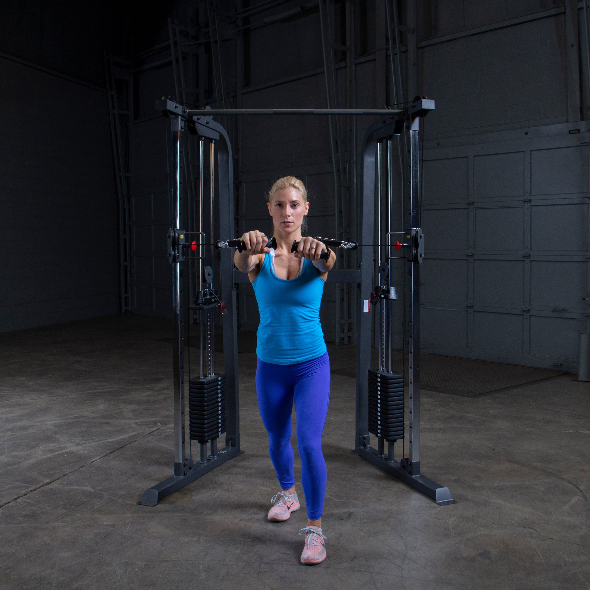Athlete performing a chest workout on Body-Solid Powerline PFT100 Functional Trainer with smooth cable operation.