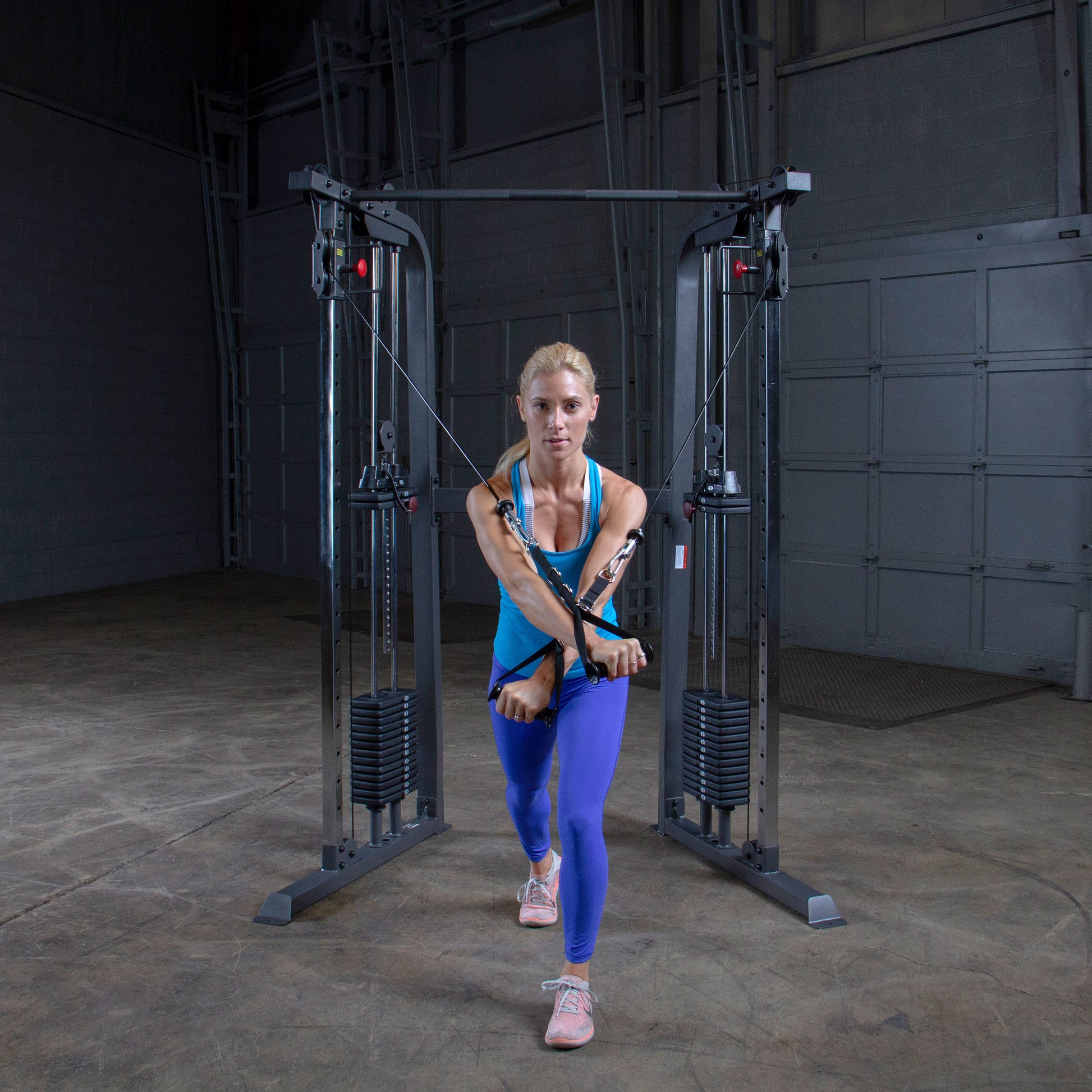 Athlete performing a full-body workout on Body-Solid Powerline PFT100 Functional Trainer with smooth cable operation.