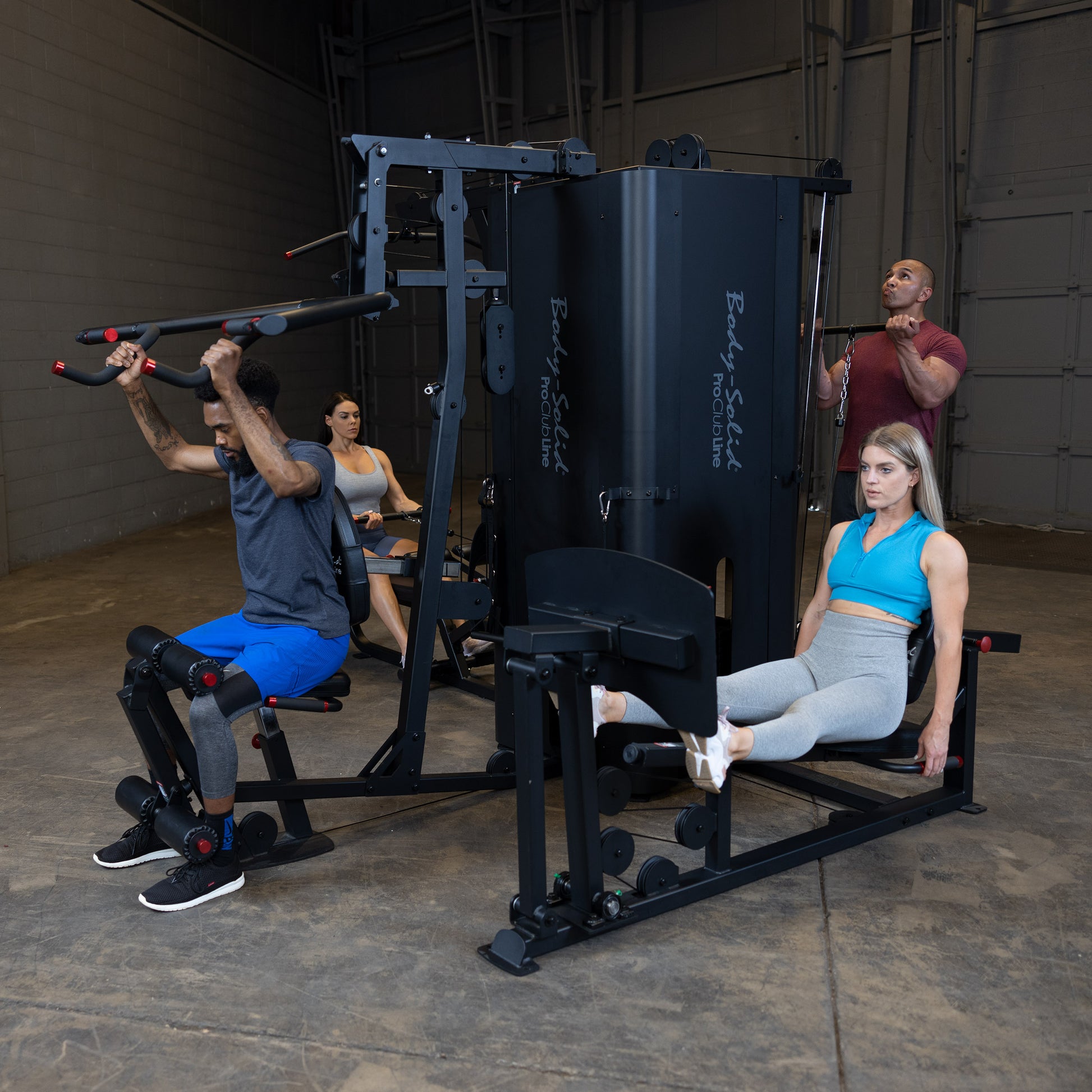 Side Angle of Four Users Training Simultaneously on Body-Solid S1000 4-Stack Gym