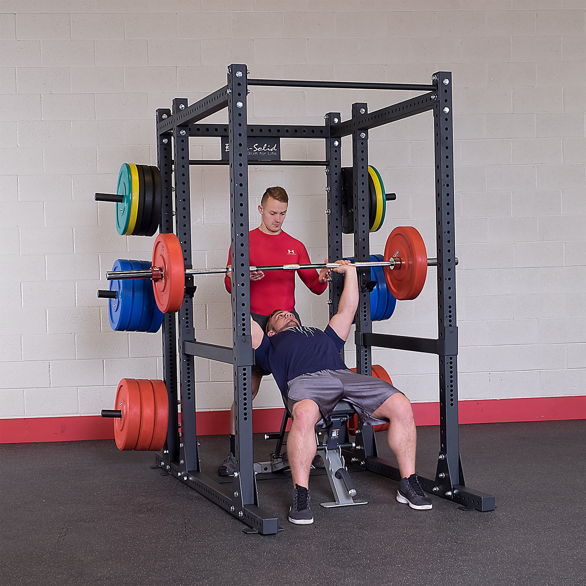Man performing bench press on the Body-Solid SPR1000 Power Rack