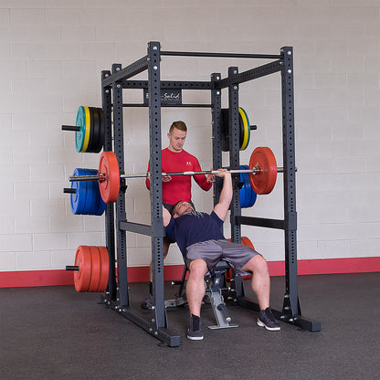 Man performing bench press on the Body-Solid SPR1000 Power Rack