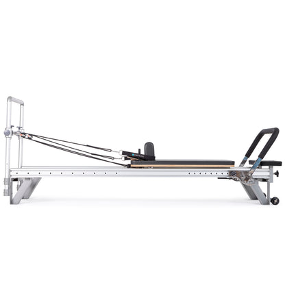 Side view of the Elina Pilates Aluminum Reformer Mentor in black upholstery with accessories attached