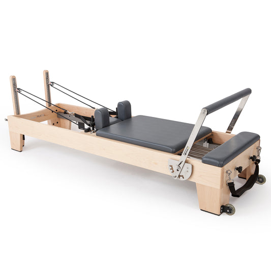 Full profile of Elina Pilates Elite Wood Reformer with black upholstery in studio setting
