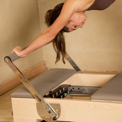 Pilates instructor performing strengthening exercises on Elina Pilates Elite Wood Reformer