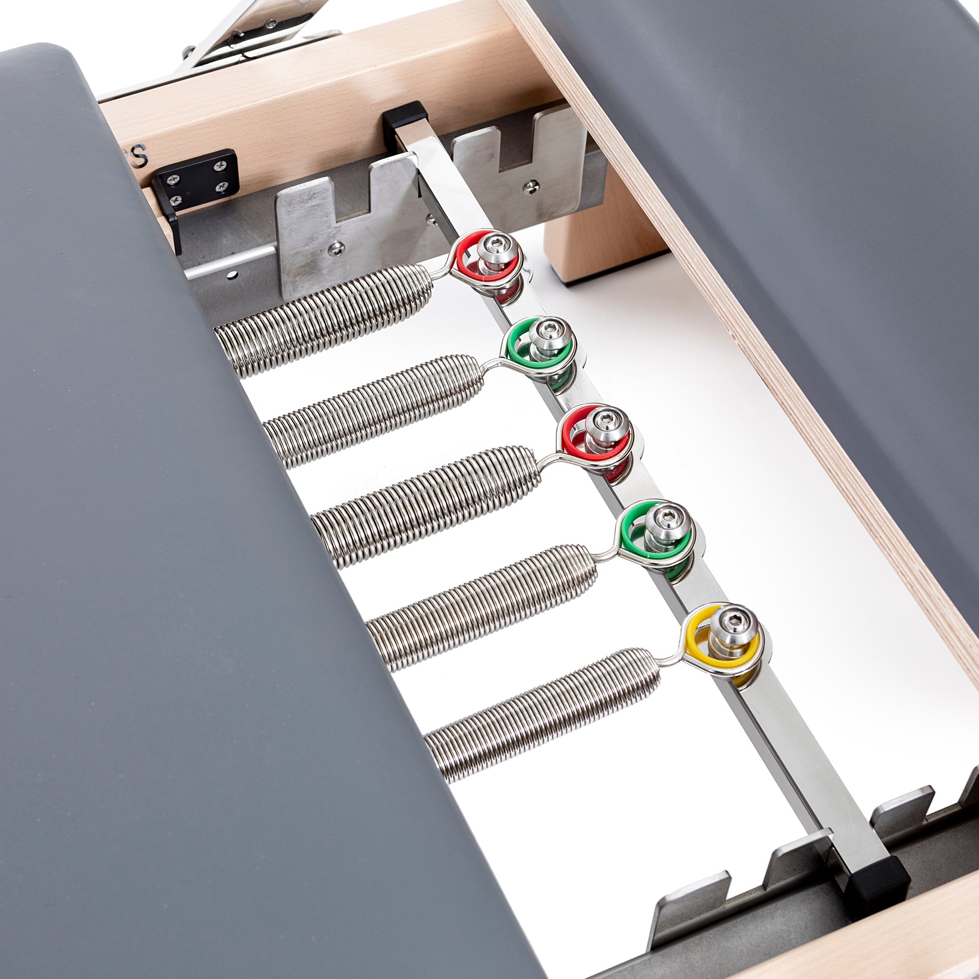 Set of color-coded resistance springs included with the Elina Pilates Wooden Reformer Lignum™ for adjustable workout intensity