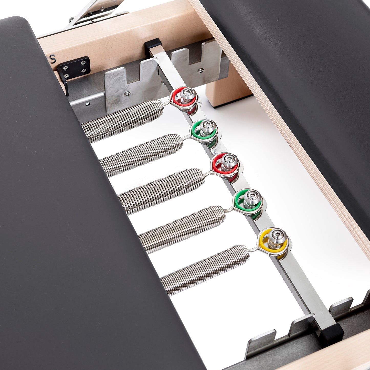 Set of color-coded resistance springs included with the Elina Pilates Wooden Reformer Lignum™ for adjustable workout intensity
