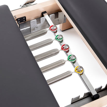 Set of color-coded resistance springs included with the Elina Pilates Wooden Reformer Lignum™ for adjustable workout intensity