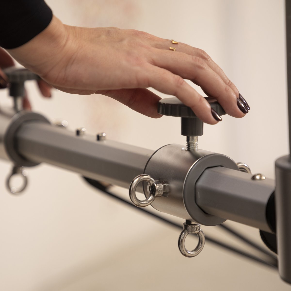 Close-up of adjustable pulleys and height settings on the Mini-Tower of the Master Instructor™ Reformer
