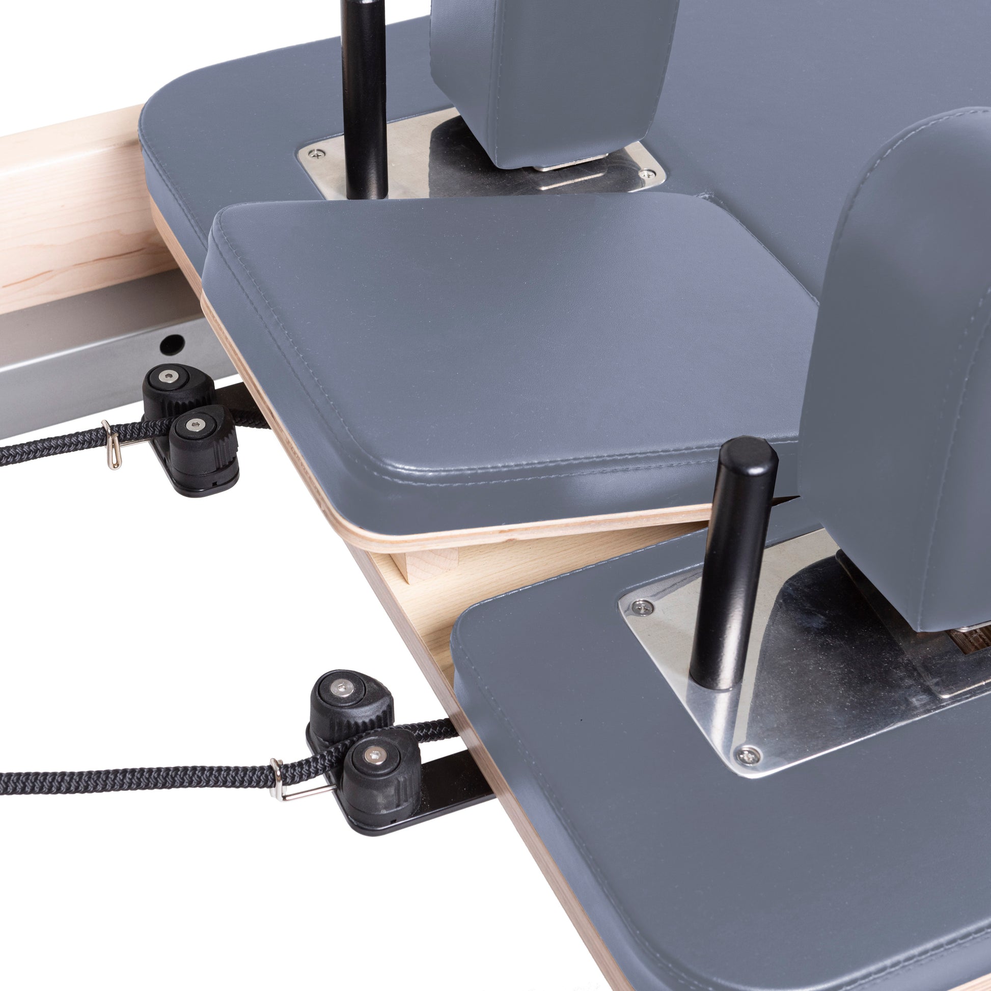 Padded shoulder rests with premium grey upholstery on the Master Instructor™ Pilates Reformer for enhanced comfort