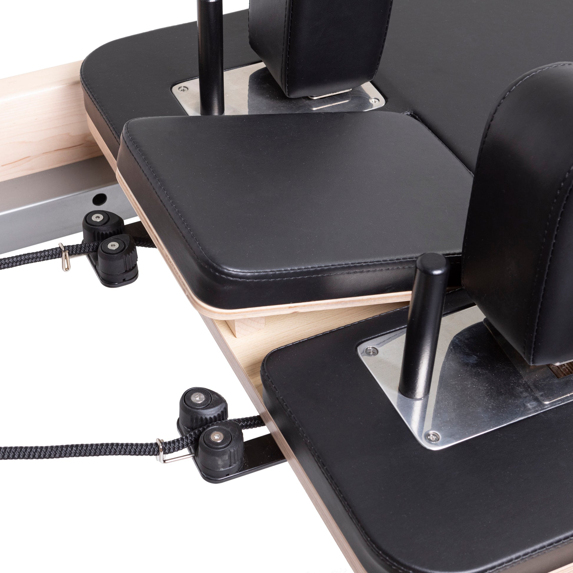 Padded shoulder rests with premium black upholstery on the Master Instructor™ Pilates Reformer for enhanced comfort
