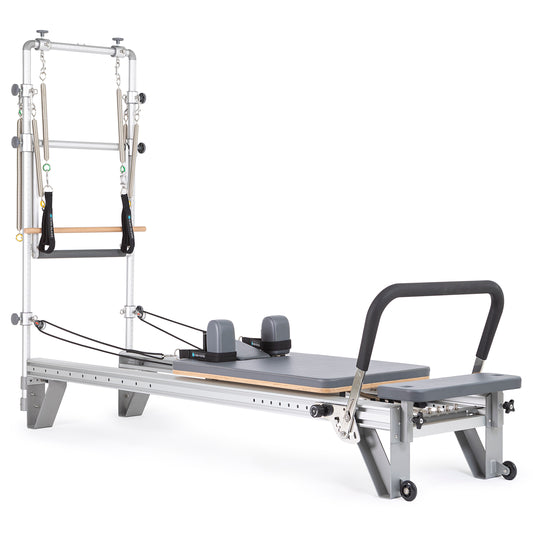Full view of the Elina Pilates Mentor Reformer with Full Tower in grey upholstery