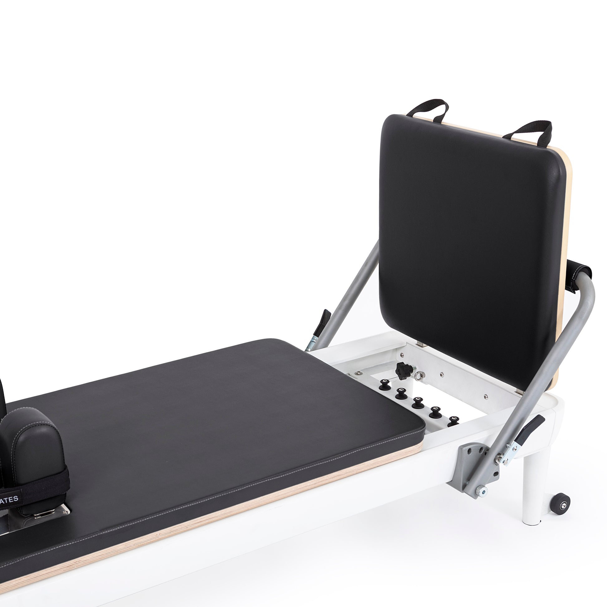 Close-up of the padded, adjustable footbar with cushioned damping on the Elina Pilates Nubium Reformer