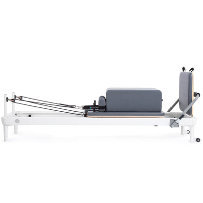 Extra-wide padded box attachment on the Elina Pilates Nubium Reformer for core and flexibility exercises