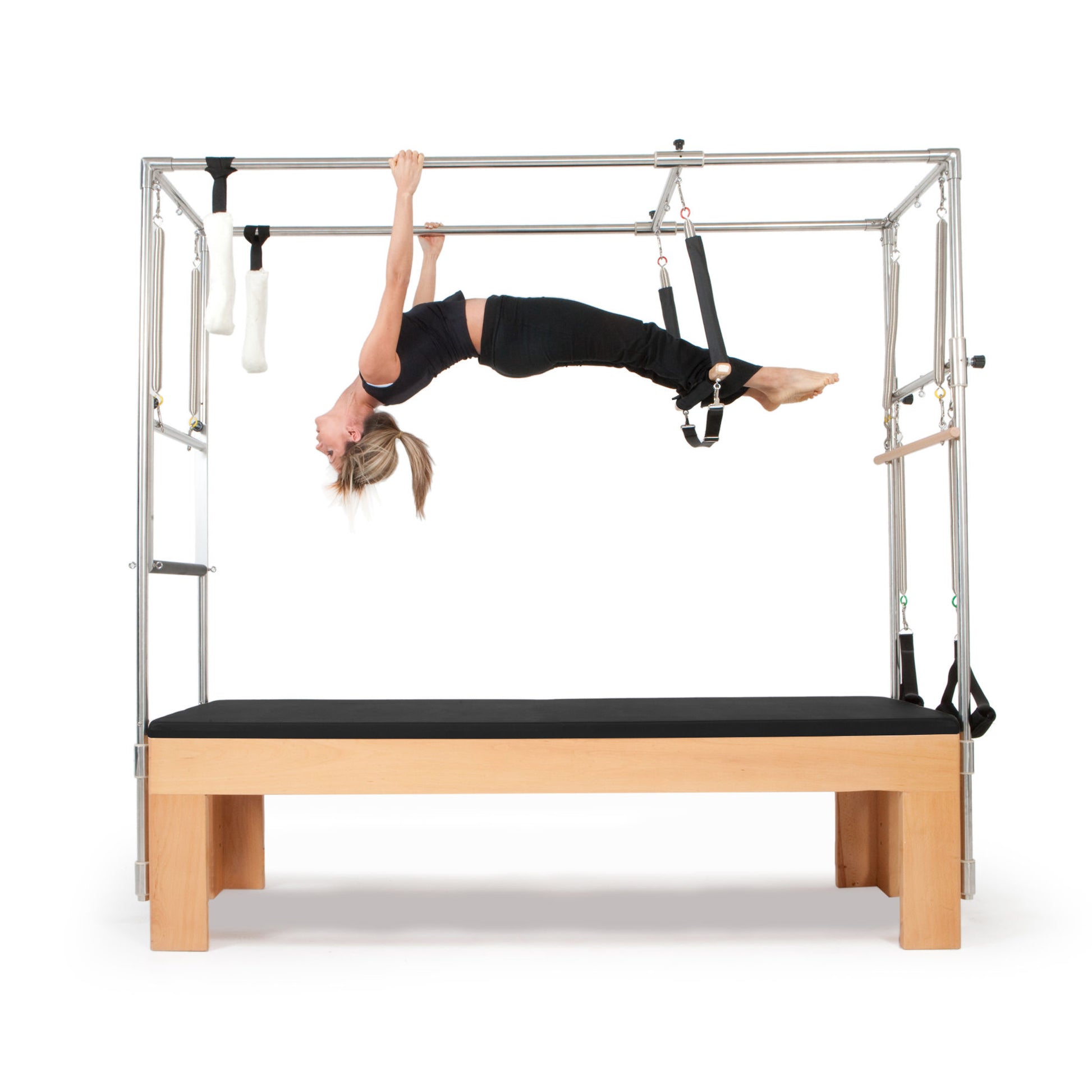 Pilates instructor demonstrating core strengthening exercises using the Elina Pilates Cadillac with black upholstery