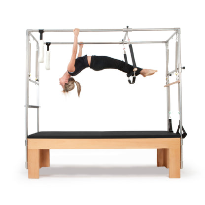 Pilates instructor demonstrating core strengthening exercises using the Elina Pilates Cadillac with black upholstery