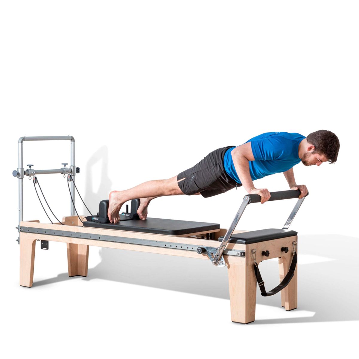 Pilates practitioner performing exercises on the Elina Pilates Physio Reformer Master Instructor with Mini-Tower in a studio setting