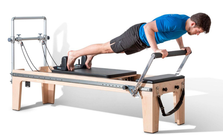 Pilates practitioner performing exercises on the Elina Pilates Physio Reformer Master Instructor with Mini-Tower in a studio setting