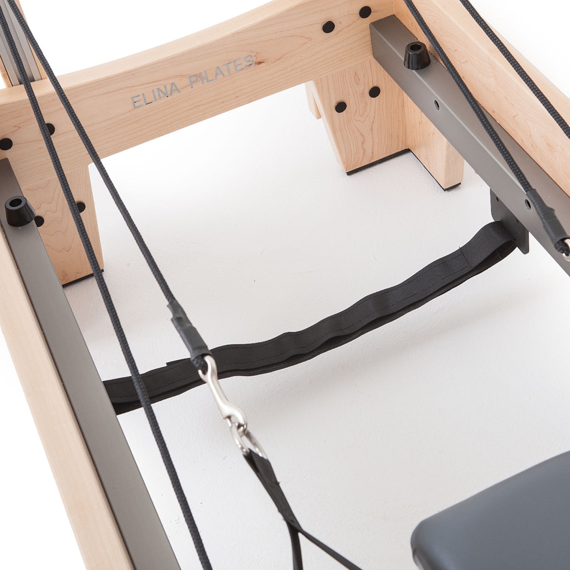 Heavy-duty spring resistance system on Elina Pilates Wood Reformer with Tower Pro for adjustable workout intensity.