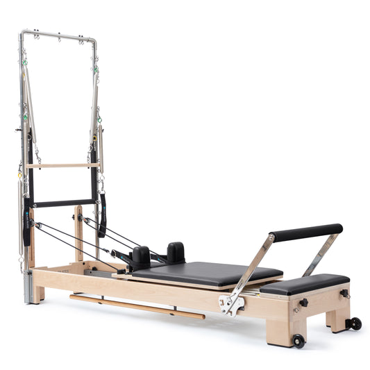 Elina Pilates Wooden Reformer Lignum with Tower in black upholstery, front view showing solid wood frame and stainless steel tower.