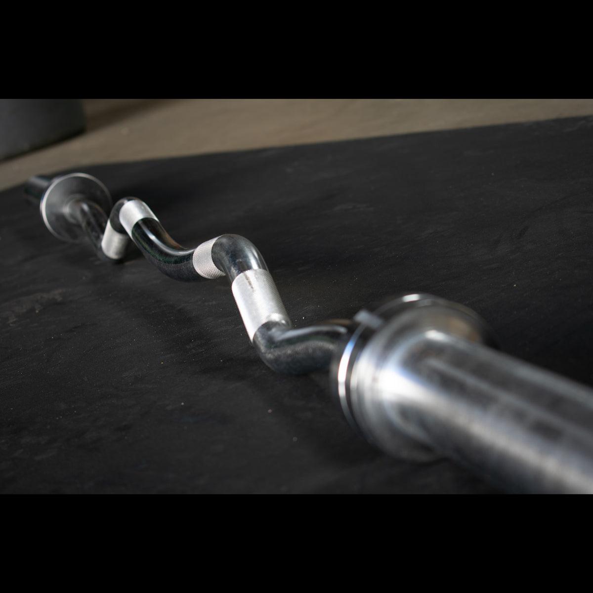 EZ curl bar loaded with plates in home gym setup