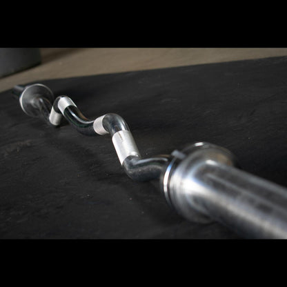 EZ curl bar loaded with plates in home gym setup