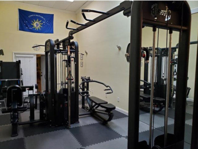 Multi-press bench and leg extension/curl station close-up