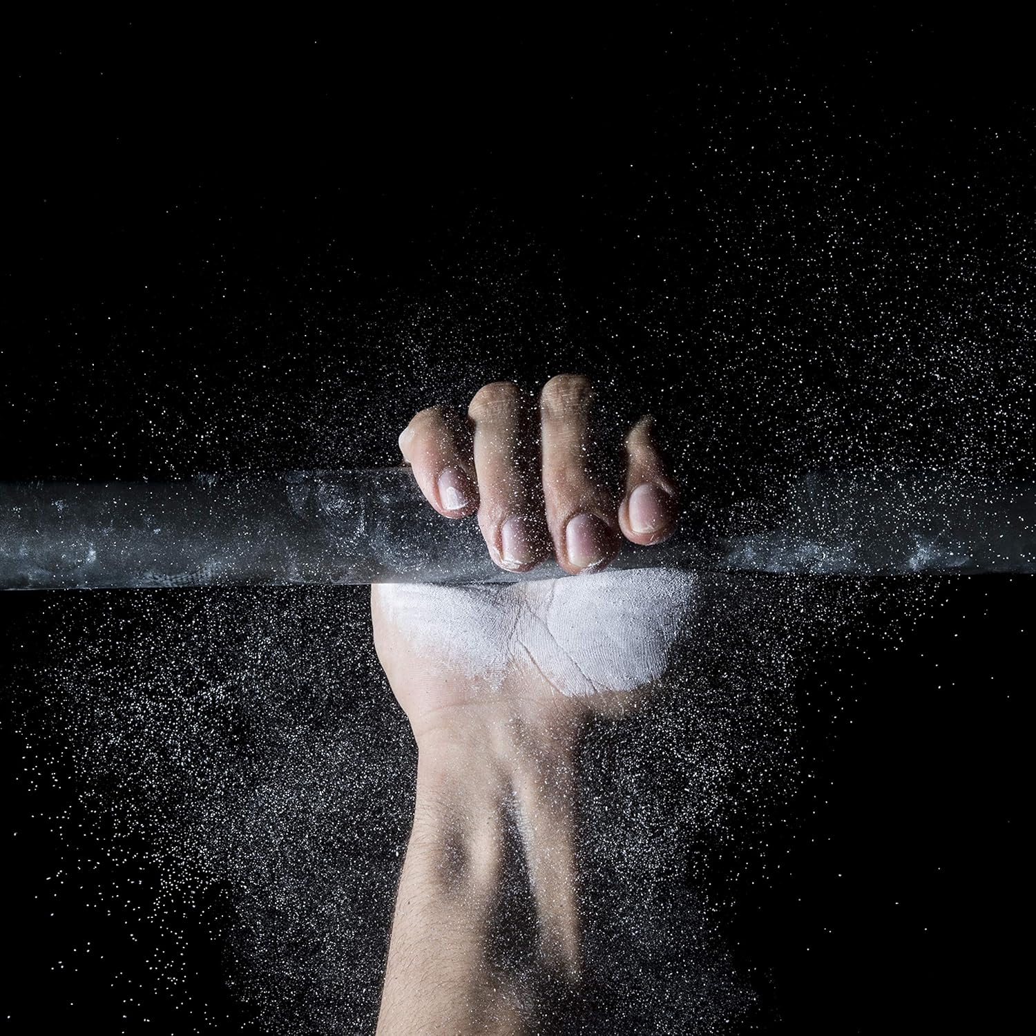 Athlete applying ProsourceFit gym chalk to hands before weightlifting workout for improved grip and performance