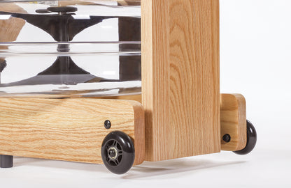 Closeup of easy transport wheels of the Topiom Natural Oak wooden water rowing machine.