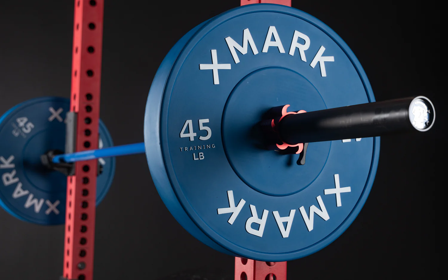 XMark chrome bumper plates loaded onto Olympic bar