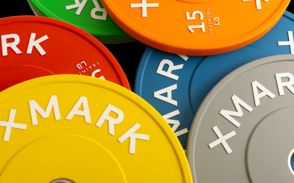 Color-coded Olympic bumper plates in all weight options