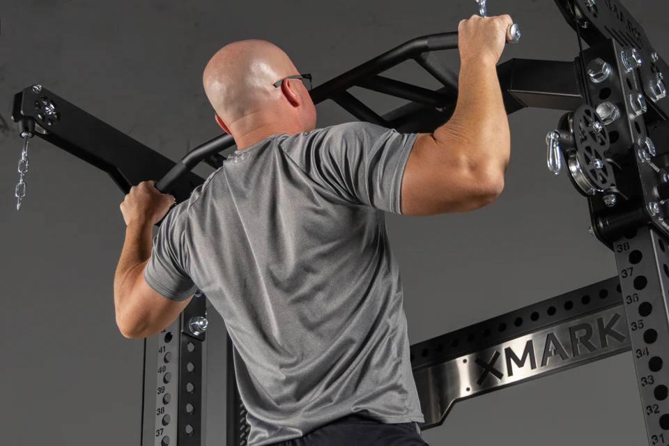 Top angle showing multi-grip pull-up bar on commercial XMark hybrid trainer