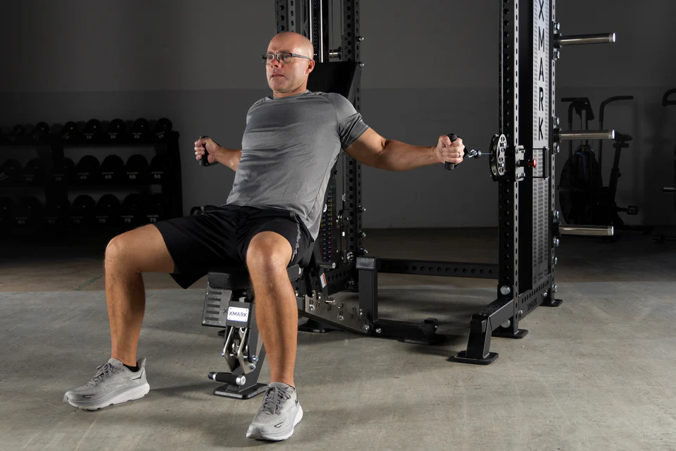 Demonstration of seated cable crossover exercise setup using adjustable pulleys