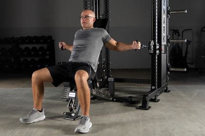 Demonstration of seated cable crossover exercise setup using adjustable pulleys