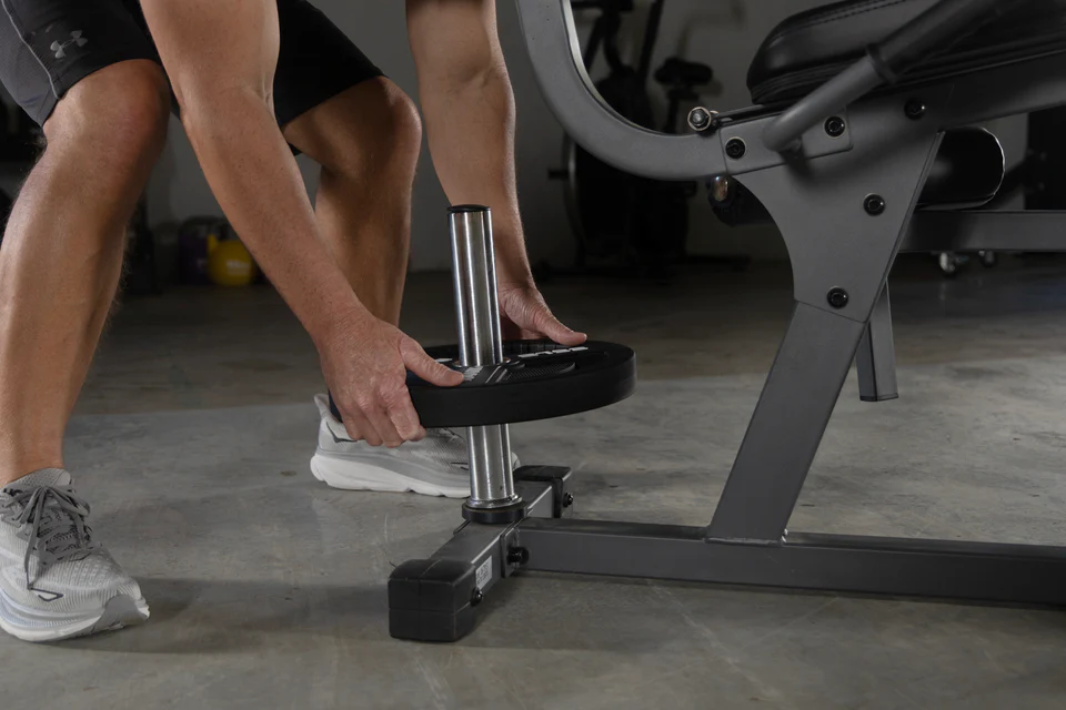 Plate storage rack on the XMark Rotary Leg Extension and Curl Machine