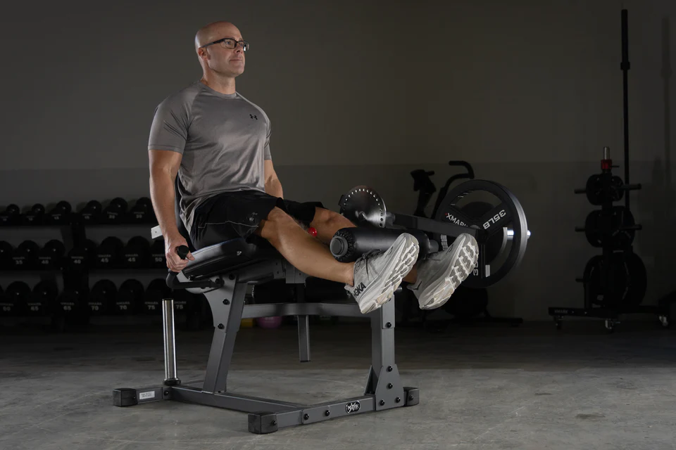 User performing leg extension with the XMark Machine
